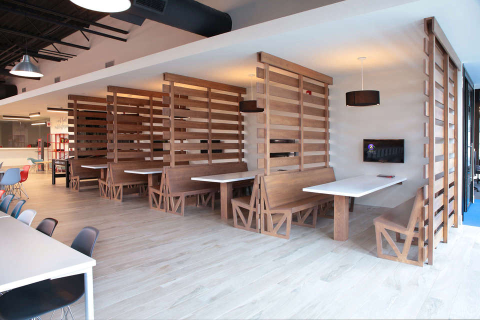 Corporate dining lounge/cafeteria, custom woodwork, benches, tables, slat partition booths, a project in London Ontario.